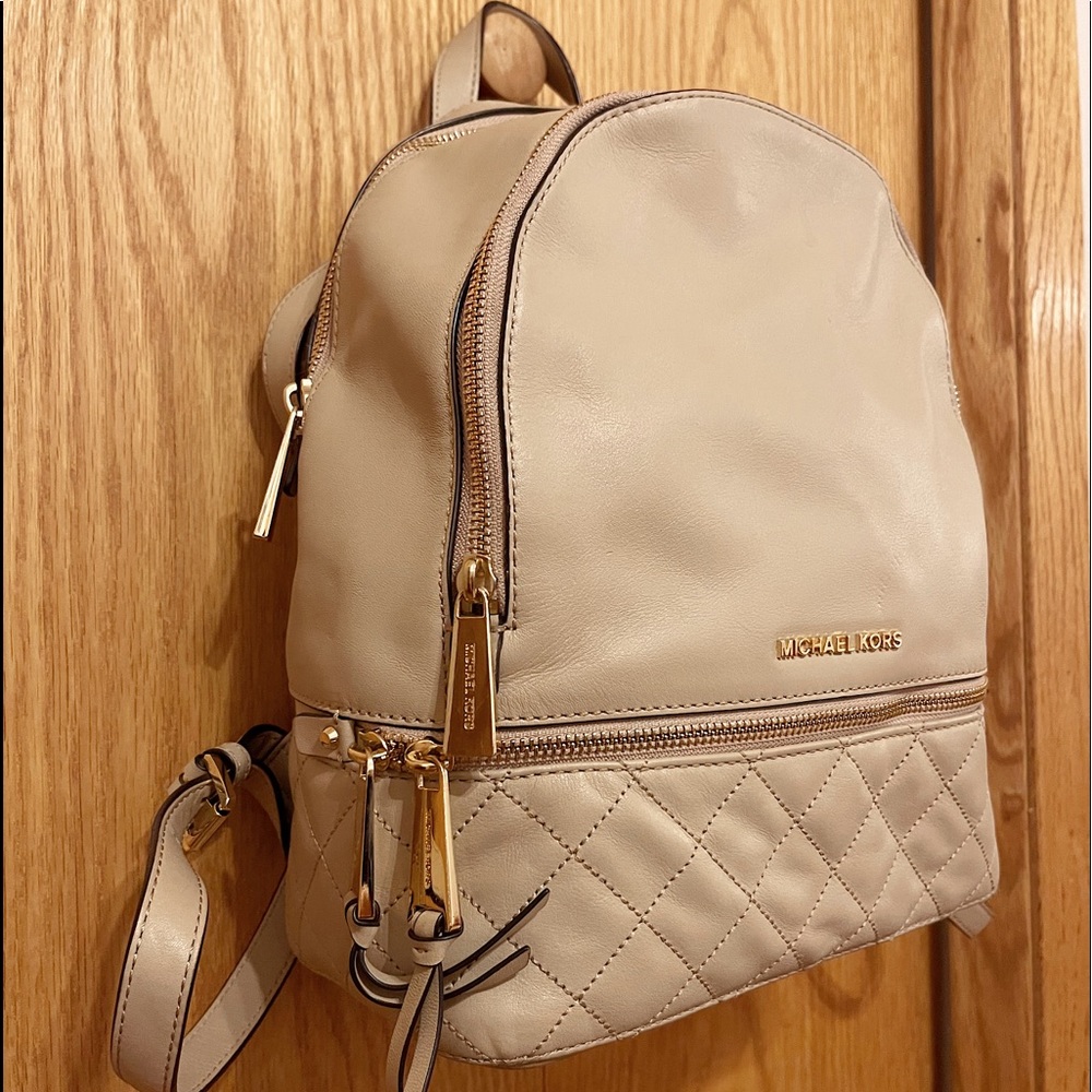 Tan Michael Kors backpack.